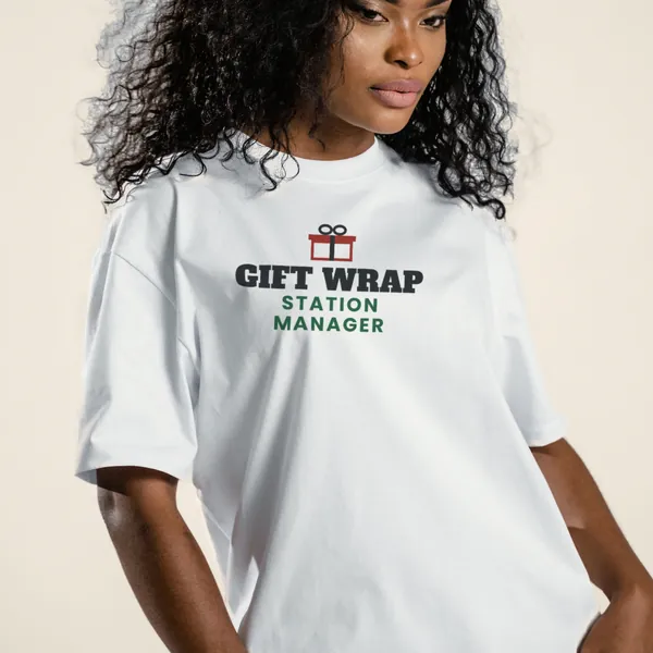 Model wearing a white "Gift Wrap Station Manager" graphic tee, front view